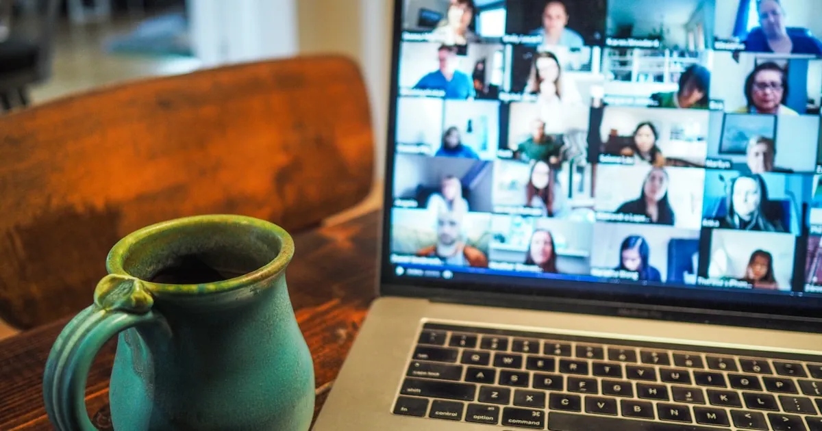 Laptop showing a Zoom video conference call with multiple participants on screen